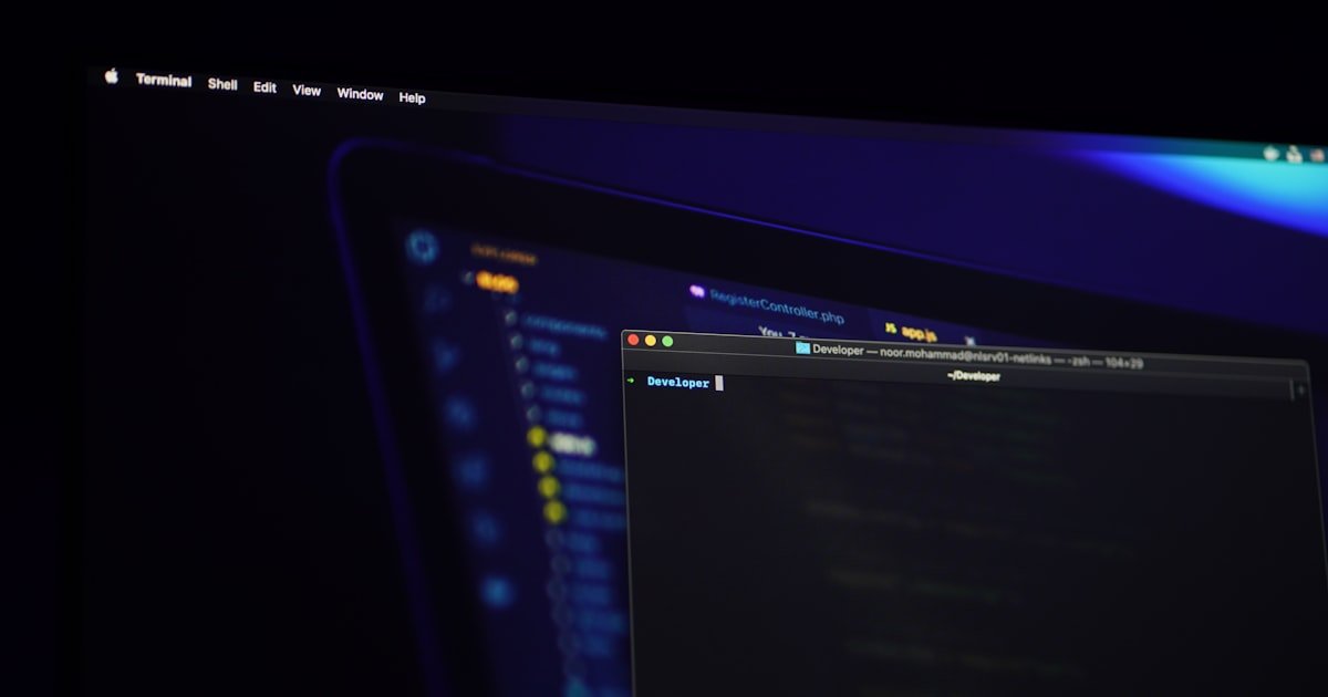 A sleek black flat-screen monitor against a minimal background, representing modern dark-theme web design for business.